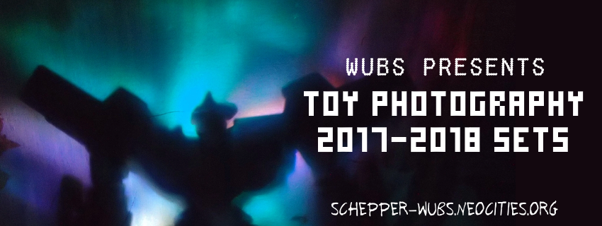 Banner graphic image: Shadow of a commanding bipedal robot standing heroicly, the light cast is turquoise with purple. Text: Wubs presents toy photography 2017-2018 sets, schepper-wubs.neocities.org