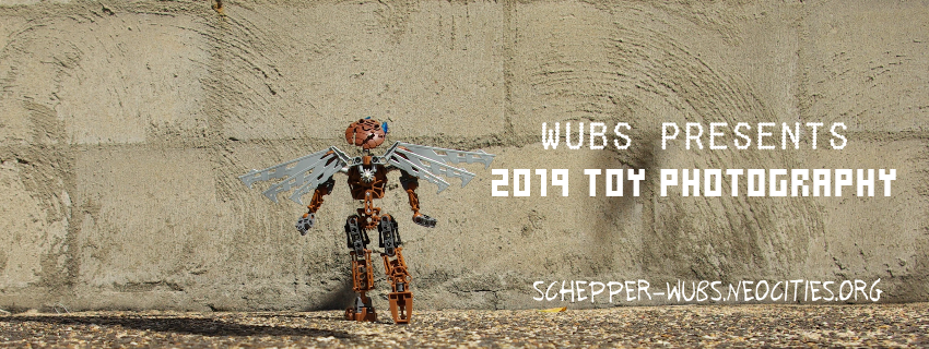 Banner graphic image: A brown Bionicle with robotic wings steps towards a brick wall while looking far upwards. Text: Wubs presents toy photography 2019 sets, schepper-wubs.neocities.org